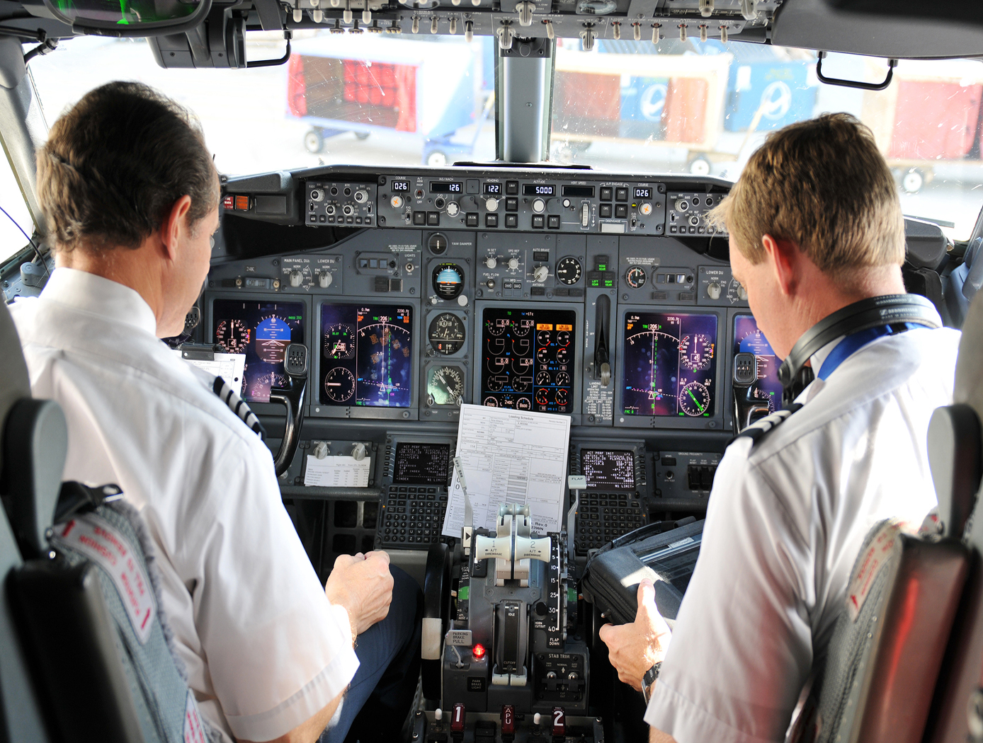 Pilots in cockpit of a plane.